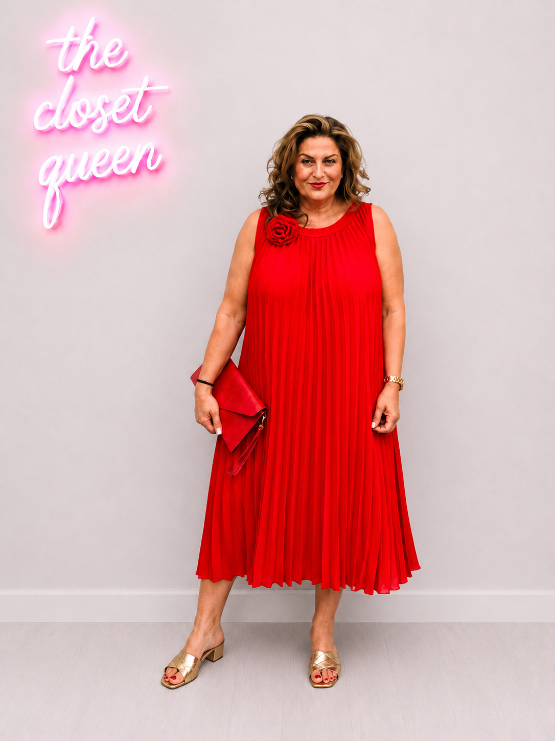 Woman in a red dress standing in front of a neon sign that reads 'the closet queen' on a gray background.